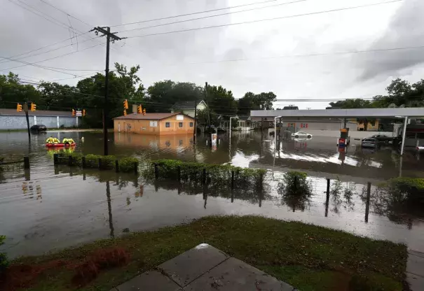 Rescue crews cross through the intersection of King St. and Huger St. after heavy rain on Tuesday, May 23, 2017. Photo: Michael Pronzato