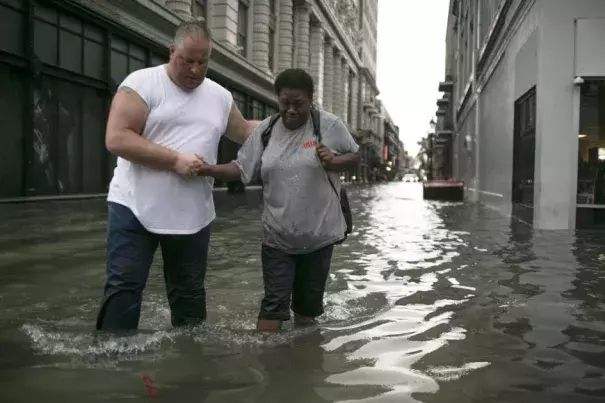 Pedestrians make their way through high water in the CBD after a downpour and flood in New Orleans. Credit: Chris Granger, NOLA