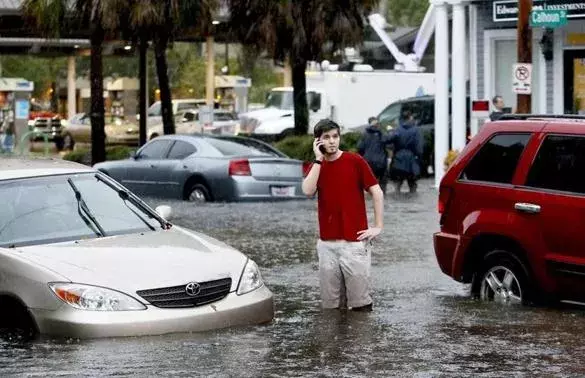 A man called for help after his car stalled in floodwaters in Charleston, S.C. in October. Photo: AP