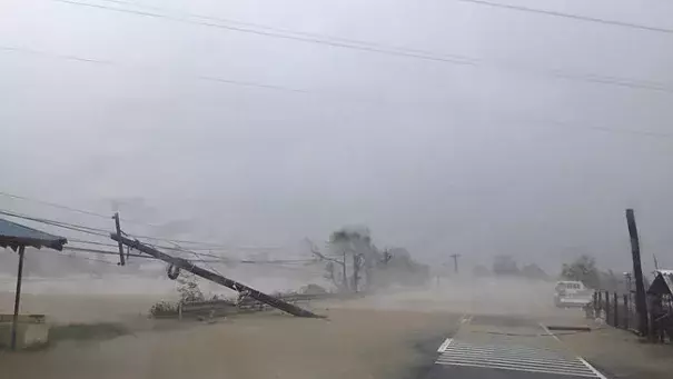 A toppled pole lays along a flooded road as heavy rains and wind from Haima battered Narvacan, Ilocos Sur, northern Philippines on Thursday, Oct. 20, 2016. Photo: Bullit Marquez, AP