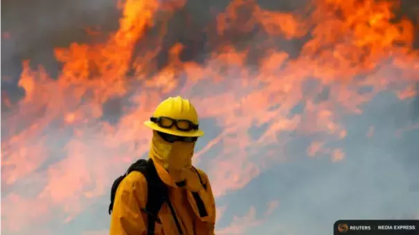 A firefighter from Chino Hills keeps watch on a wildfire as it burns near Potrero, Calif. Photo: Mike Blake, Reuters