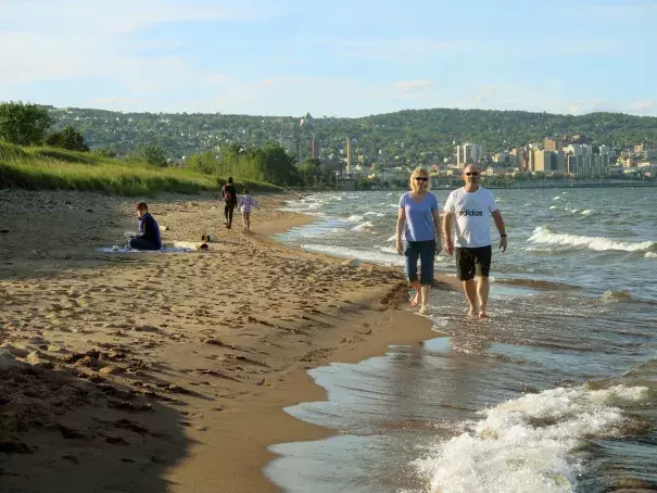 A couple walks along the Lake Superior shoreline at Park Point in Duluth. Photo: Dan Kraker | MPR News