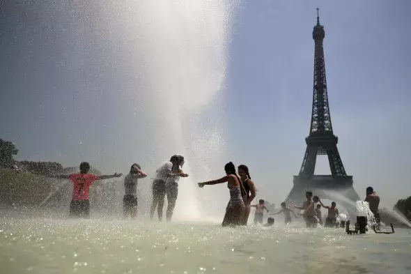 Youngsters cool off at the Trocadero public fountain in Paris, Wednesday, June 26, 2019. Credit: Francisco Seco, AP