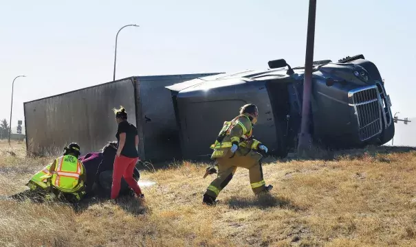 Paramedics tend to an injured person near a highway in Colorado Springs, CO. (Credit: Jerilee Bennett, AP Images)