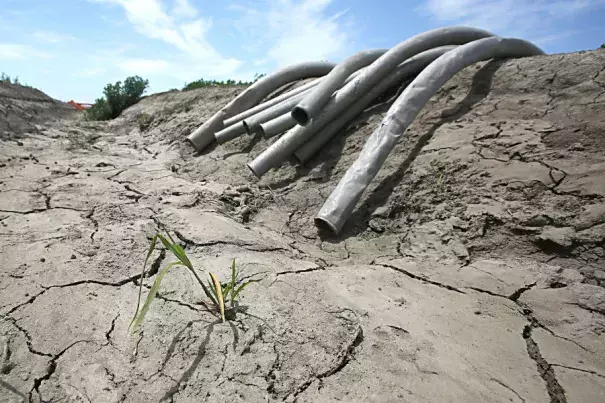 Irrigation pipes sit along a dried irrigation canal on a field farmed by Gino Celli near Stockton, Calif. last spring amid some of the broadest water cuts on record. Photo: Rich Pedroncelli, AP