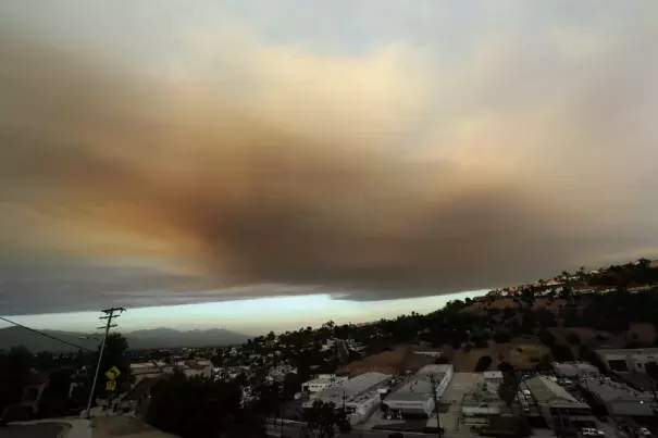 Smoke from a nearby wildfire looms over Los Angeles on Friday, viewed from Monterey Park, Calif. Photo: Nick Ut/AP