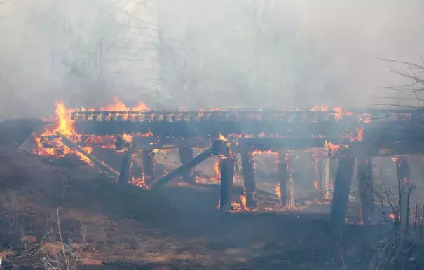 A old train trestle bridge burns near Lake City, KS, on Wednesday, March 23, 2016. The bridge was set afire by a large grass fire burning in Barber County, KS. Lake City is about 15 miles northwest of Medicine Lodge, where at least two homes were destroyed by fire. Photo: Travis Morisse, The Hutchinson News via AP