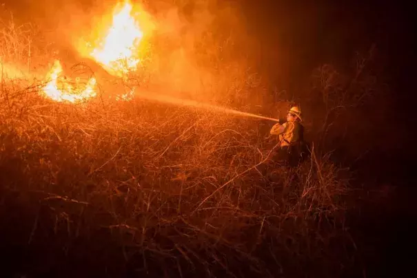 Firefighter, Tyler McManigal, fights the Alisal Fire in Refugio Canyon, Oct. 12, 2021, Gaviota, Calif. (Erick Madrid/ZUMA Press)