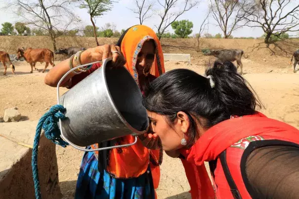 A woman quenches her thirst during the hot summer day outskirts of Jaipur, Rajasthan. Temperature records are rapidly getting shattered as North Indian states and towns are left to sizzle under extreme heat conditions. Photo: Vishal Bhatnagar, Zuma Press