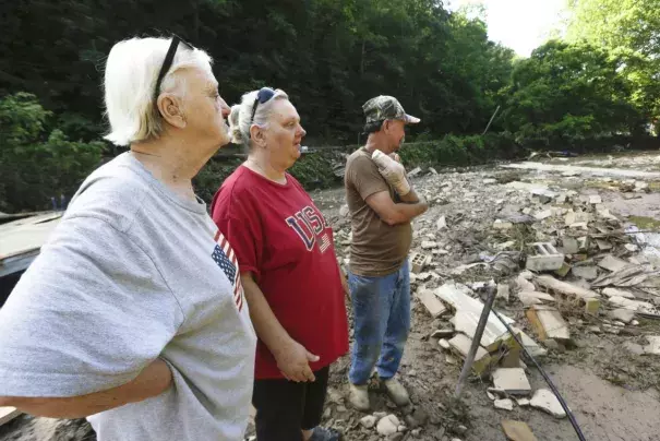 Emma Allen, center, and James Allen look at the remnants of their home after flooding damage with Pauline Stanley in Clendenin, W.Va., on Sunday. Photo: Marcus Constantino / Reuters