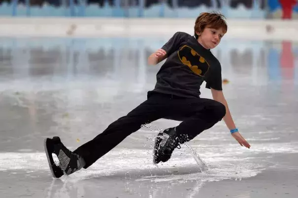 As New York City experienced an unseasonably warm month, a young skater slipped on a huge puddle of water from the melted ice at the Bryant Park rink. Photo: Timothy A. Clary, Agence France-Presse, Getty