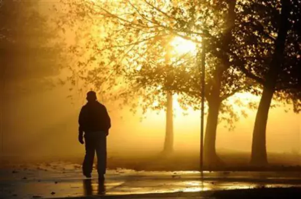 Chong O(cq), of Sherman Oaks, takes advantage of clearing skies to walk through the morning mist at Lake Balboa Park in Lake Balboa, Calif., Thursday, Jan. 7, 2016. The tail-end of a series of several El Nino-driven storms brought scattered showers and isolated thunderstorms to Southern California Thursday along with pounding surf and serious winds. (AP Photo/Michael Owen Baker)