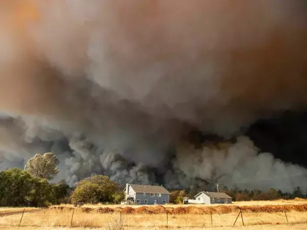 Towering smoke plumes overshadowed California's town of Paradise as the Camp Fire raced through in 2018. More than 18,000 acres burned in a matter of hours. (Credit: Josh Edelson/AFP via Getty Images)