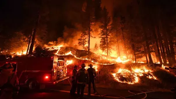 Firefighters try to control a back burn as the Carr fire continues to spread towards the towns of Douglas City and Lewiston near Redding, California, in July 2018. (Credit: Mark Ralston/AFP/Getty Images)