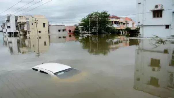 A car is submerged amidst water-logged houses in a rain-hit area of Chennai. (AFP)