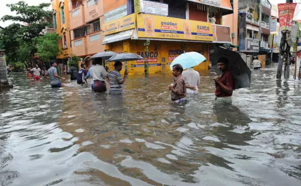 People wade through a flooded street in Chennai, in the southern Indian state of Tamil Nadu, on Wednesday, December 2, 2015. Image credit: AP.