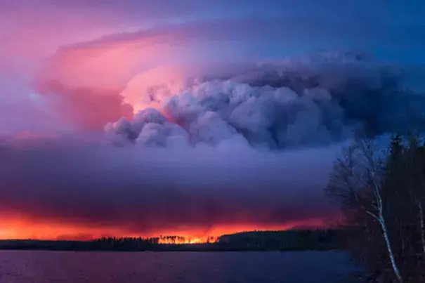 A massive wildfire rages Wednesday evening, May 4, 2016, near Anzac, Alberta, a hamlet 48 km southwest of Fort McMurray. The community and surrounding area was evacuated. A state of emergency exists in the Regional Municipality of Wood Buffalo as a result of wildfires. Photo: Chris Schwarz, Government of Alberta via Creative 