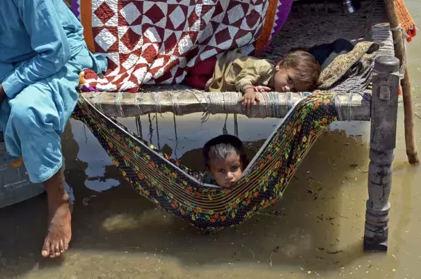 Children in Balochistan province caught up in the Pakistan floods last year. UN secretary general António Guterres called it a ‘monsoon on steroids’. (Credit: Fida Hussain/AFP/Getty Images)