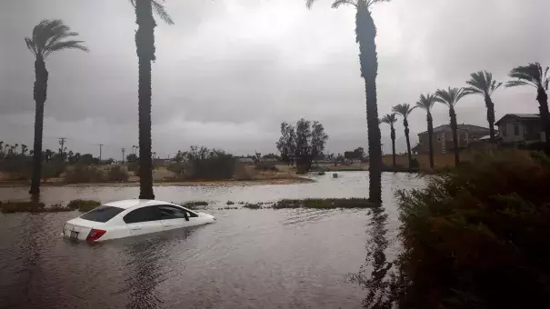 A car is partially submerged in floodwaters from Tropical Storm Hilary in Cathedral City, Calif. on Aug. 20. (Credit: Mario Tama/Getty Images)