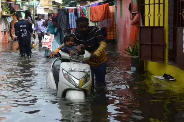 People wade through a flooded street in a residential area after heavy monsoon rain in Chennai, India, on Nov. 12. (Arun Sankar/AFP/Getty Images)