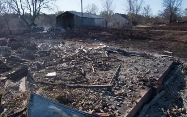 The remains of a homestead smolder Friday after a wildfire destroyed it and other buildings west of Medicine Lodge. Photo: Oliver Morrison, The Wichita Eagle