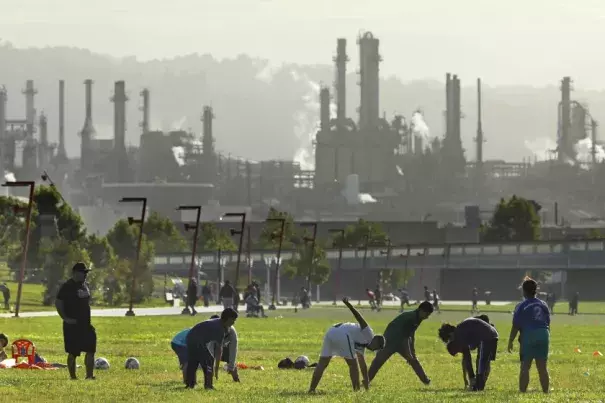 Youth activities go on at Wilmington Waterfront Park, in the shadow of the Phillip 66 Los Angeles refinery. The community of Wilmington, near the Port of Los Angeles, has one of the highest ozone levels in the United States. (Carolyn Cole / Los Angeles Times/Los Angeles Times)