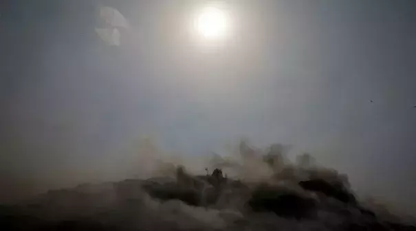 An excavator tries to contain a fire amid an extreme heat wave in New Delhi.