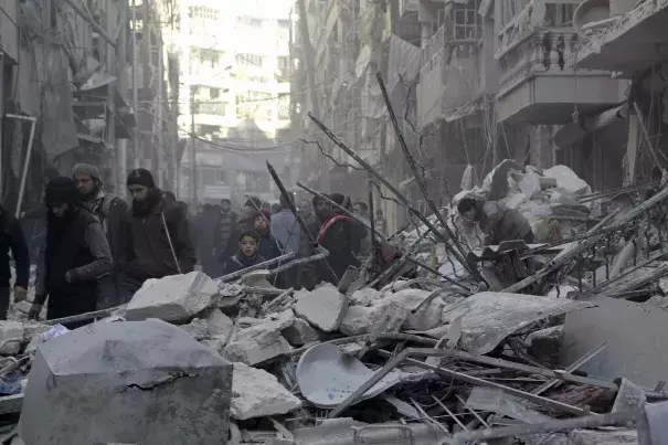 Residents inspect damage after airstrikes by pro-Syrian government forces in the rebel held Al-Shaar neighborhood of Aleppo, Syria February 4, 2016. Photo: Abdalrhman Ismail, Reuters