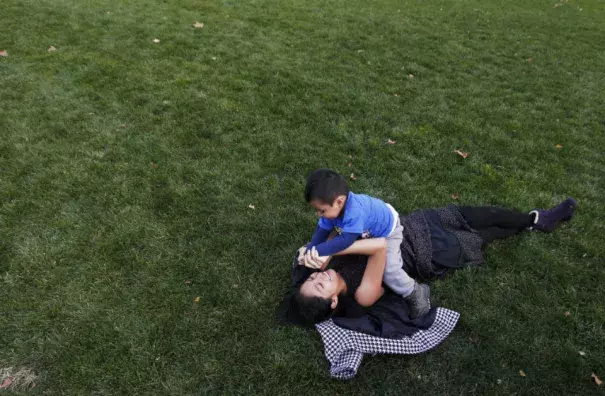 Older sister Yisenia Malla plays with younger brother Moses Malla as Newark's Military Park still has green grass to go with the the warm weather in Newark 12/13/15 (Ed Murray | NJ Advance Media for NJ.com)