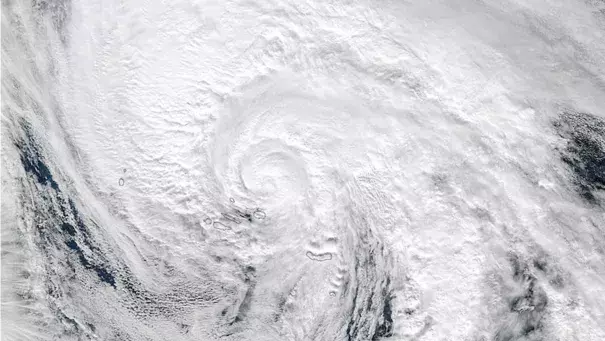 MODIS visible satellite image of Tropical Storm Alex at 9:20 am EST Friday, January 15, 2016. About an hour earlier, Alex’s western eywall passed over the Azores island of Terceira (black outline below the center of Alex). Image: NASA