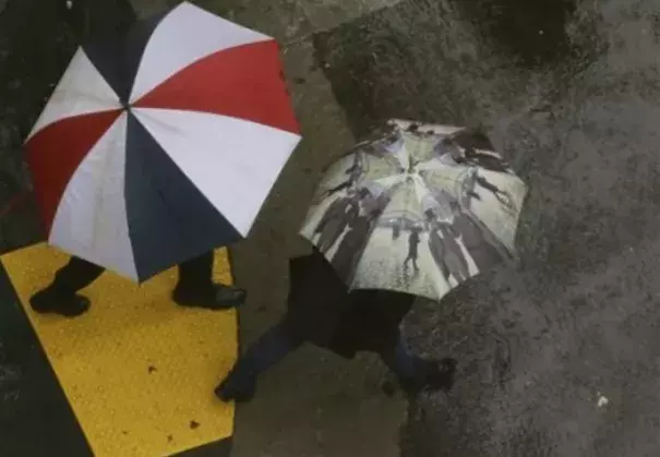 Successive storms bringing rain and snow this weekend could considerably ease California's ongoing fears of drought, according to the National Weather Service. Here, San Francisco pedestrians rely on umbrellas to stay dry. Photo: Jeff Chiu, AP