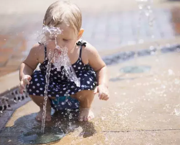 Athena Meeks, 2, tastes the water as she plays in the fountain at Mathias Mitchell Public Square in downtown Stevens Point, Tuesday, July 19, 2016. Photo: Megan McCormick / USA Today Network - Wisconsin