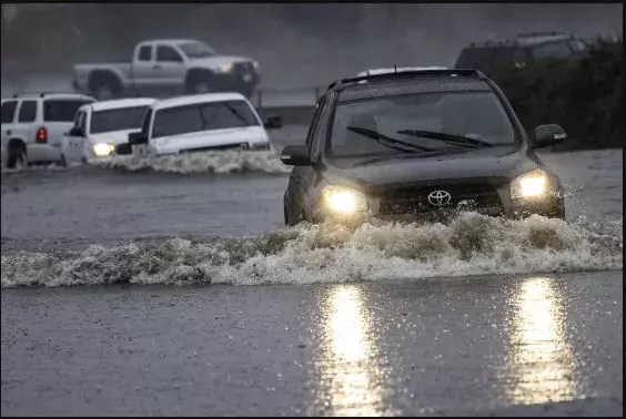 Car drives through flooded water