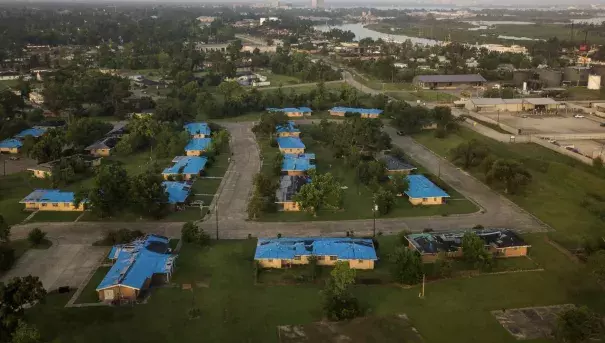 Almost two years after Hurricane Laura swept through Lake Charles, many roofs are still covered by tarps. (Credit: Edmund D. Fountain/New York Times)