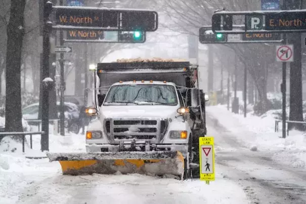 A snowplow clears a street in Greenville, S.C., on Sunday. (Sean Rayford/Getty Images)