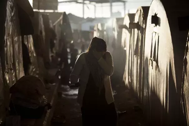 A Syrian refugee woman is seen between a line of tents in a refugee camp near Azaz, north of Aleppo province, Syria. Photo: Manu Brabo, AP