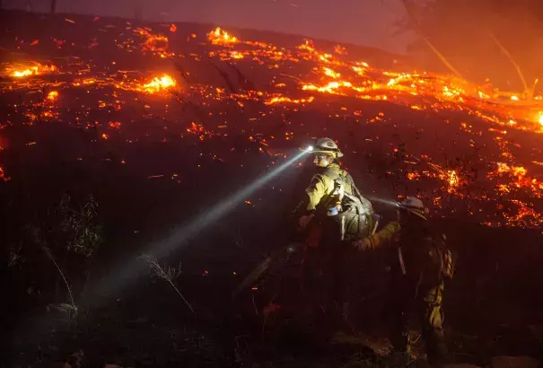 U.S. Forest Service firefighters cut brush near houses in northern Wenatchee, Wash., on June 28 as the Sleepy Hollow Fire spread quickly, fueled by low humidity and strong winds. Photo: Don Seabrook, Wenatchee World, AP