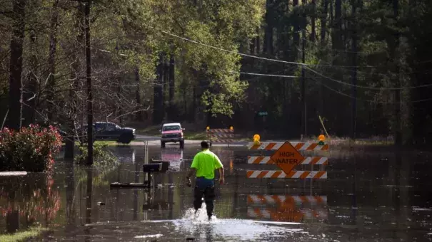 A man walks through floodwaters from Caddo Lake in Mooringsport, La., Sunday, March 13, 2016. President Barack Obama has signed an order declaring Louisiana's widespread flooding from heavy rains a major disaster. Photo: Lee Celano/The Shreveport Times via AP