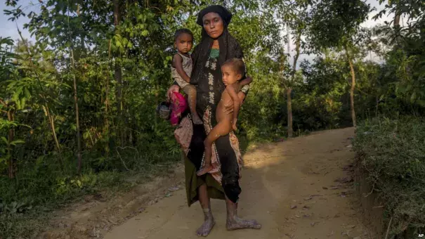 A Rohingya Muslim woman Zahida Banoo holds her son Mohammad Noor, left, and daughter Shah Heer as she poses for a photograph on the way to her shelter in Kutupalong refugee camp, Bangladesh, Friday, Sept. 15, 2017. Those packed into camps and makeshift settlements in Bangladesh are becoming desperate for scant basic resources as hunger and illness soared. Photo: AP