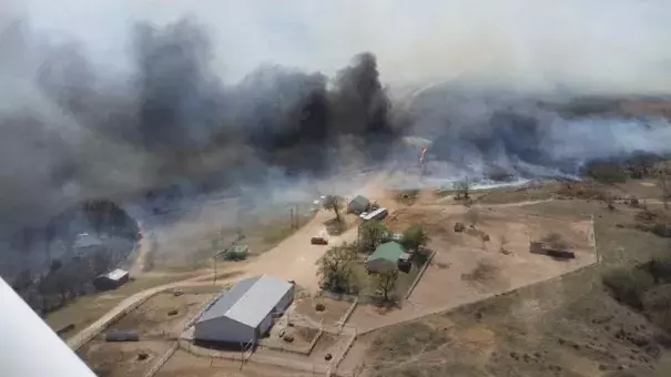 A wildfire rages in Sun City, Kansas, Wednesday after jumping across Highway 160 and crossing over from Oklahoma. Voluntary evacuations were made due to the threat of the fire. Photo: Deb Farris, KAKE News)