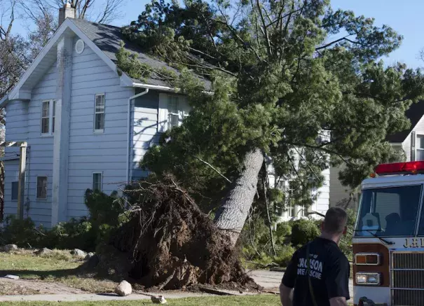 Jackson Fire Department personnel respond to a gas leak after a tree fell on a house in Jackson, Mich., on Wednesday, March 8, 2017. Photo: J. Scott Park, Jackson Citizen Patriot via AP