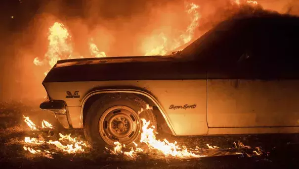 Flames from the Wall Fire consume a vintage Chevrolet Super Sport near Oroville. Photo: NBC Southern California via AP