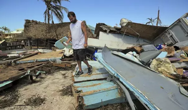Eric Ward, the bartender at Key Largo's Snappers, inspects the damage from Hurricane Irma at the popular restaurant on Tuesday, Sept. 12, 2017, in Key Largo, Fla. Florida is cleaning up and embarking on rebuilding from Hurricane Irma, one of the most destructive hurricanes in its history. Photo: Al Diaz, Miami Herald via AP