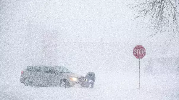 Daniel Marks digs his car out after getting stuck in a snowstorm Monday, Jan 22, 2018, in Norfolk, Neb. Photo: Ryan Soderlin, Omaha World-Herald via AP)