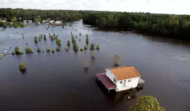 A house is surrounded by floodwaters from Hurricane Florence in Lumberton, N.C., Monday, Sept. 17, 2018. Credit: Gerald Herbert, AP