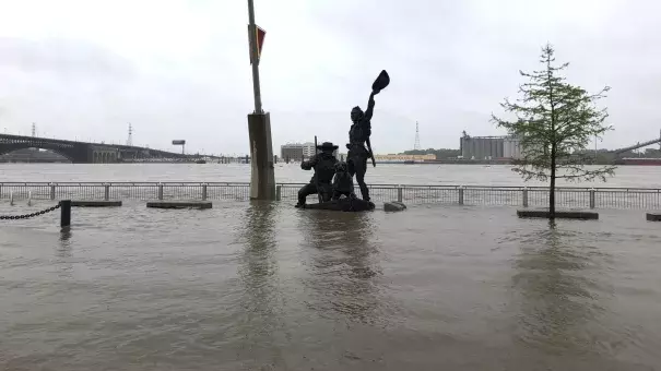 A statue of explorers Lewis and Clark is surrounded by floodwaters along the St. Louis riverfront on Thursday. Credit: Jim Salter, AP