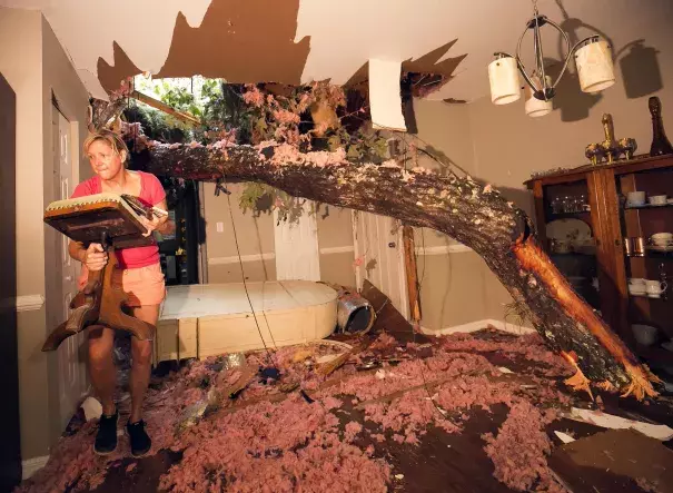 Storm victim, Susan Griffin, saves a piece of furniture from the home she was renting after a tree fell on the home in Ocala, FL. Photo: Doug Engle, Star-Banner