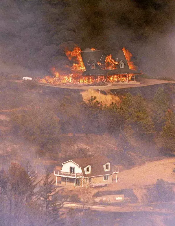 A structure burns near Loma Prieta Road and Loma Chiquita Road in Santa Clara County on Monday. Photo: Vern Fisher - Monterey Herald