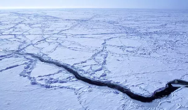 An ice lead in the Arctic Ocean is captured from the NSF/NCAR C-130 aircraft as it flies roughly 30 meters (100 feet) above the ocean during a field project studying low-level ozone formation. Photo: James Hannigan, UCAR