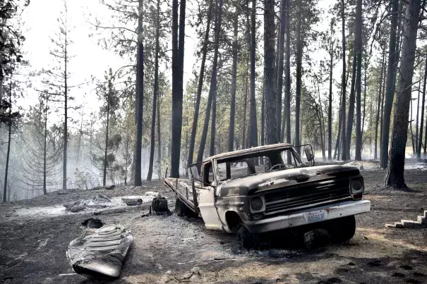 A charred truck is seen near the home of Julie Thayer and her husband, Art, on South Yale Road near Valleyford, Spokane County, on Monday. The Thayers had been hiking over the weekend and returned home. Photo: Tyler Tjomsland, The Spokesman-Review